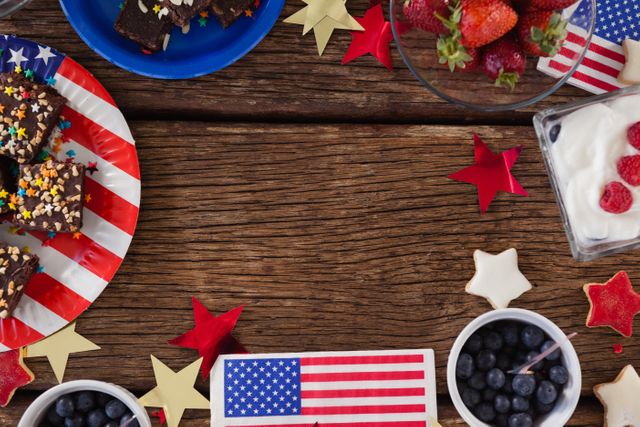 Festive 4th of July themed dessert table featuring a variety of sweets and fruits. Ideal for use in holiday celebration promotions, patriotic event advertisements, and social media posts highlighting Independence Day festivities.