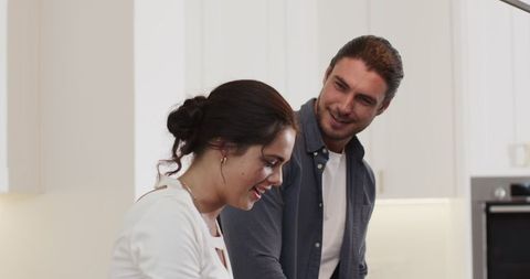 Happy Couple Enjoying Culinary Experience in Modern Kitchen
