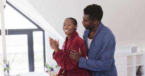 Joyful Couple Embracing in Morning Self-Care Ritual