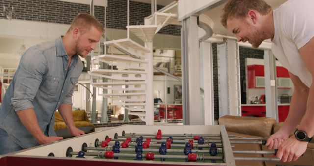 Friends Playing Foosball in Modern Living Room - Download Free Stock Images Pikwizard.com