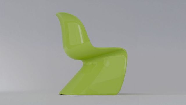 Glossy lime cantilever chair featuring curved modern plastic design on pale-gray surface