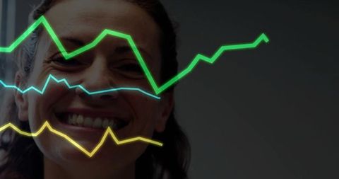 Smiling professional with trend lines in business analytics