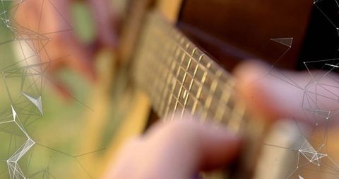 Person Playing Acoustic Guitar Outdoors Visual Representation of Music