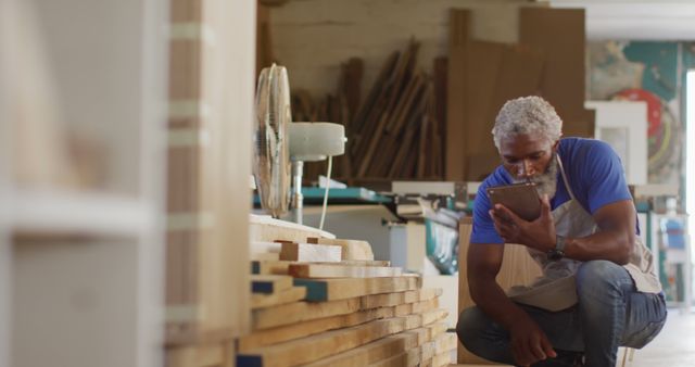 Carpenter Checking Digital Plans in Workshop - Download Free Stock Images Pikwizard.com