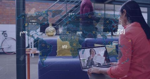Remote team collaborating via video conference in coworking lounge with map overlay