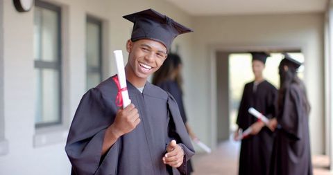 Proud Graduate Celebrating Academic Success with Friends - Download Free Stock Images Pikwizard.com