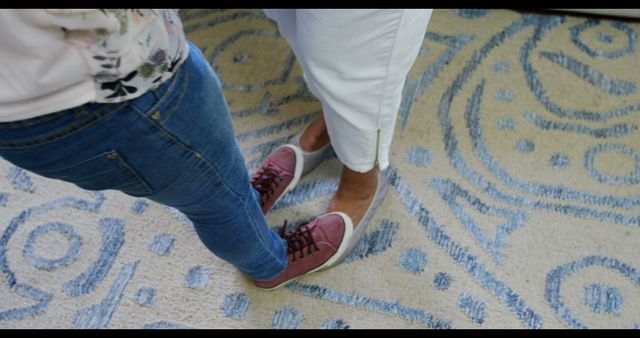 Two People Playing Foot Game on Carpet with Colorful Shoes - Download Free Stock Images Pikwizard.com