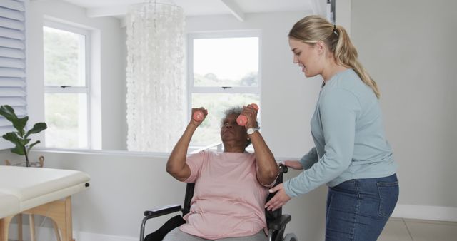 Physical therapist assists senior woman in wheelchair doing arm exercises - Download Free Stock Images Pikwizard.com