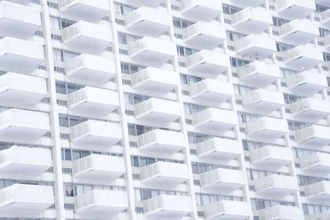 Abstract perspective of identical white condo balconies on skyscraper
