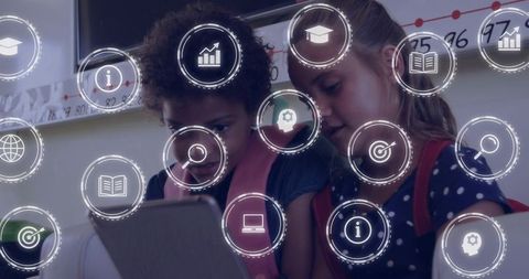 Two young students collaborating on tablet in classroom with digital education icons