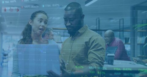 Diverse Business Team Discusses Financial Data with Digital Display