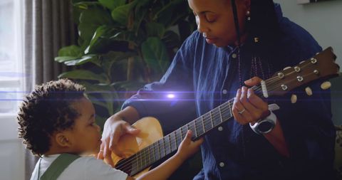 Mother Teaching Son Guitar in Sunlit Living Room - Download Free Stock Images Pikwizard.com