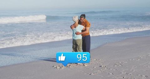 Senior Couple Embracing by Waves with Iconic Like Symbol