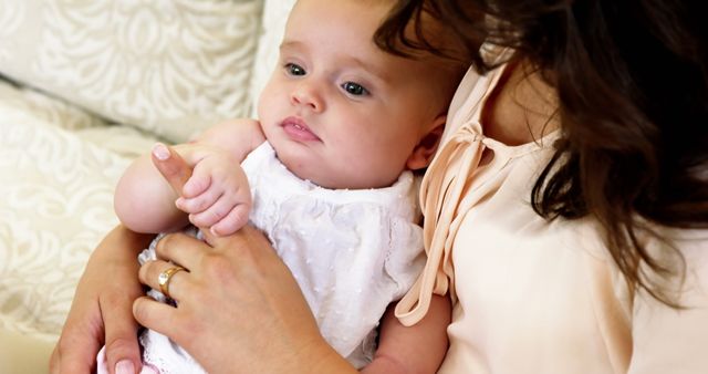 Mother Holding Baby on Sofa in Living Room, Cozy Family Moment - Download Free Stock Images Pikwizard.com