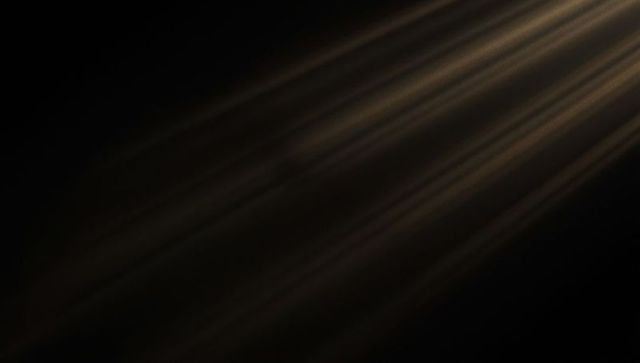 Golden brown light streaks on dark background