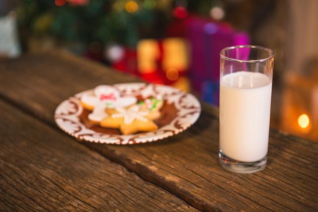 Gingerbread cookies with a glass of milk on wooden table during christmas time