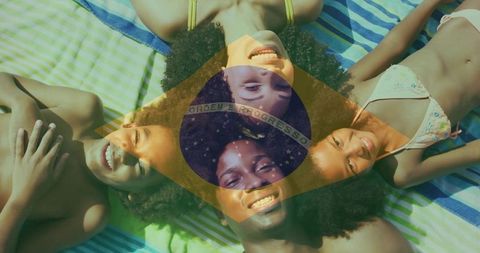Smiling family lying in circle on beach towels with brazil flag overlay, summer vacation