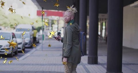 Modern Urban Lifestyle: Man using smartphone on city sidewalk with star graphics