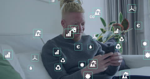 Man Engaging with Energy and Ecology Icons at Home on Smartphone