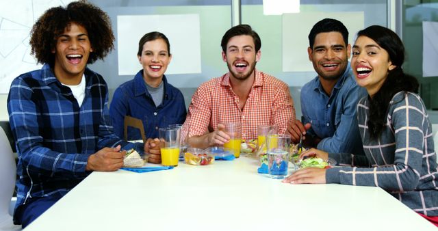 Diverse Group of Friends Enjoying Meal Together at a Bright Cafe - Download Free Stock Images Pikwizard.com