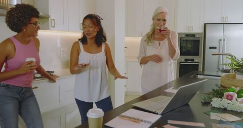 Bride-to-Be Planning Wedding with Friends in Modern Kitchen