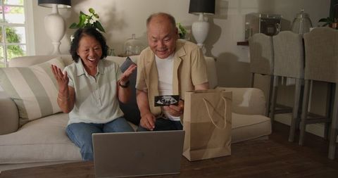 Senior Asian Couple Excitedly Viewing Ultrasound on Video Call