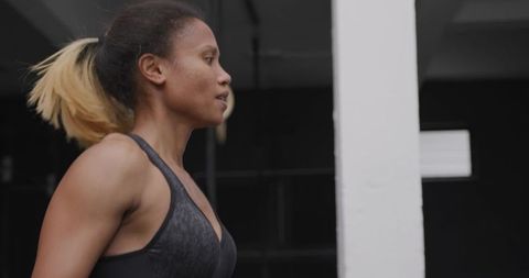 Determined woman exercising in gym with focus and precision