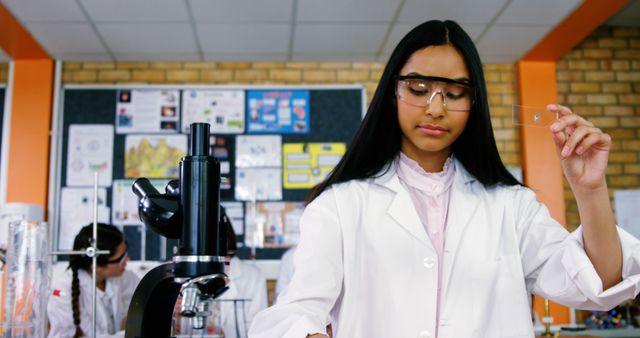 Young Female Scientist Conducting Lab Experiment in Classroom - Download Free Stock Images Pikwizard.com