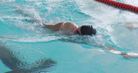 Male Swimmer Executing Crawl Stroke in Indoor Pool Lane - Download Free Stock Images Pikwizard.com