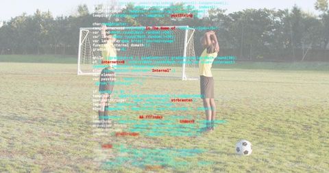 Youth Soccer Teammates Practicing Penalty Kick with Code Overlay Symbolizing Sports Tech