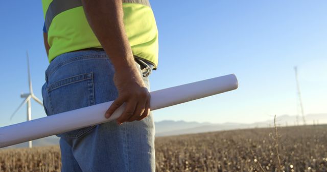 Engineer Holding Blueprint at Wind Farm - Download Free Stock Images Pikwizard.com