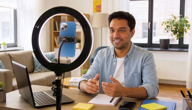 Recording Vlogger in Home Workspace with Ring Light and Smartphone, Casual Remote Creator