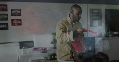Teacher demonstrating fire extinguisher in classroom safety drill