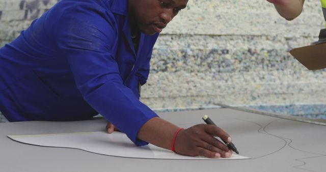 African American Craftsman Tracing Pattern on Cloth in Workshop - Download Free Stock Images Pikwizard.com