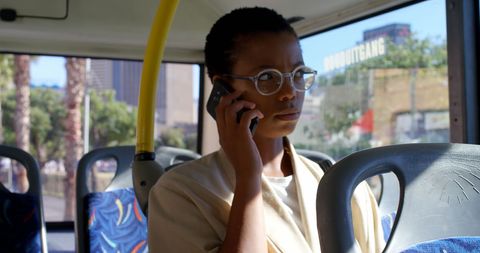 Professional Woman Commuting by Bus Engaged in Phone Call