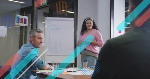 Diverse Team Collaborating on Marketing Strategy with Flip Chart