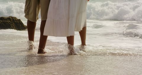 Romantic Beach Walk with Feet in Tide