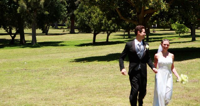 Happy Newlyweds Running in Lush Green Park after Wedding Ceremony - Download Free Stock Images Pikwizard.com