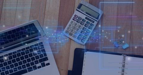 Modern finance workspace flatlay showing laptop calculator planner and data overlay