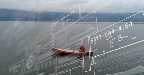 Solitary paddler wearing red jacket in wooden canoe on misty lake with digital schematic overlay