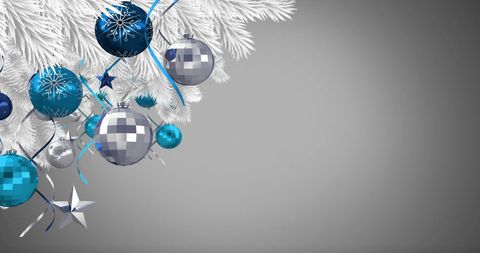 White Christmas Tree with Blue and Silver Ornaments Against Gray Background