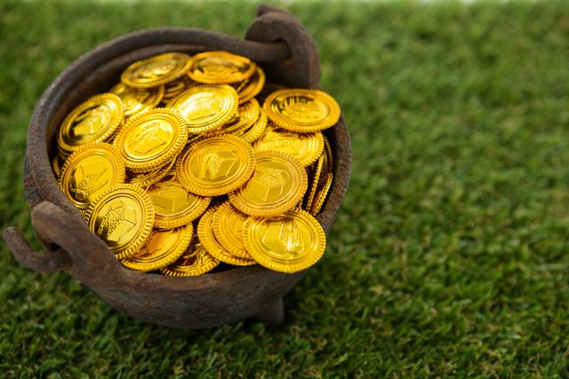 St. Patricks Day pot filled with chocolate gold coins on grass