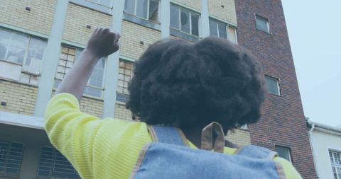 Confident Individual Raising Fist for Empowerment