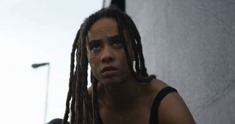 Focused Young Woman Tying Shoelaces Outdoors