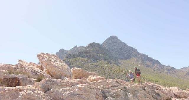 Father and Child Exploring Rocky Mountain Terrain on Sunny Day - Download Free Stock Images Pikwizard.com