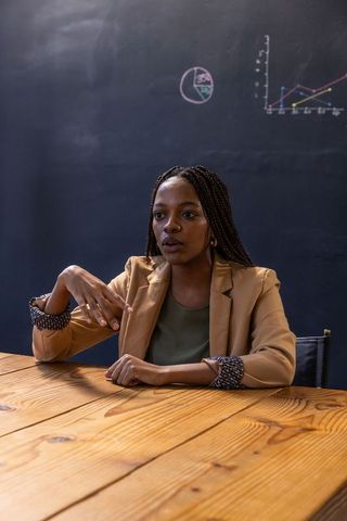 African American Businesswoman Presenting in Modern Conference Room