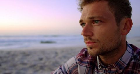 Thoughtful Young Man Relaxing on Beach During Sunset - Download Free Stock Images Pikwizard.com