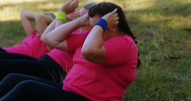 Diverse individuals demonstrate the value of physical activity through an outdoor sit-up session. - Download Free Stock Photos Pikwizard.com