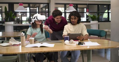 Students Exploring Virtual Reality Together in Campus Lounge with Tablet Collaboration