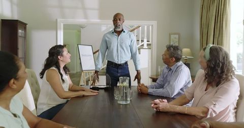 Senior Leader Guiding Diverse Team at Home Discussion